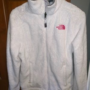 white zip up north face jacket